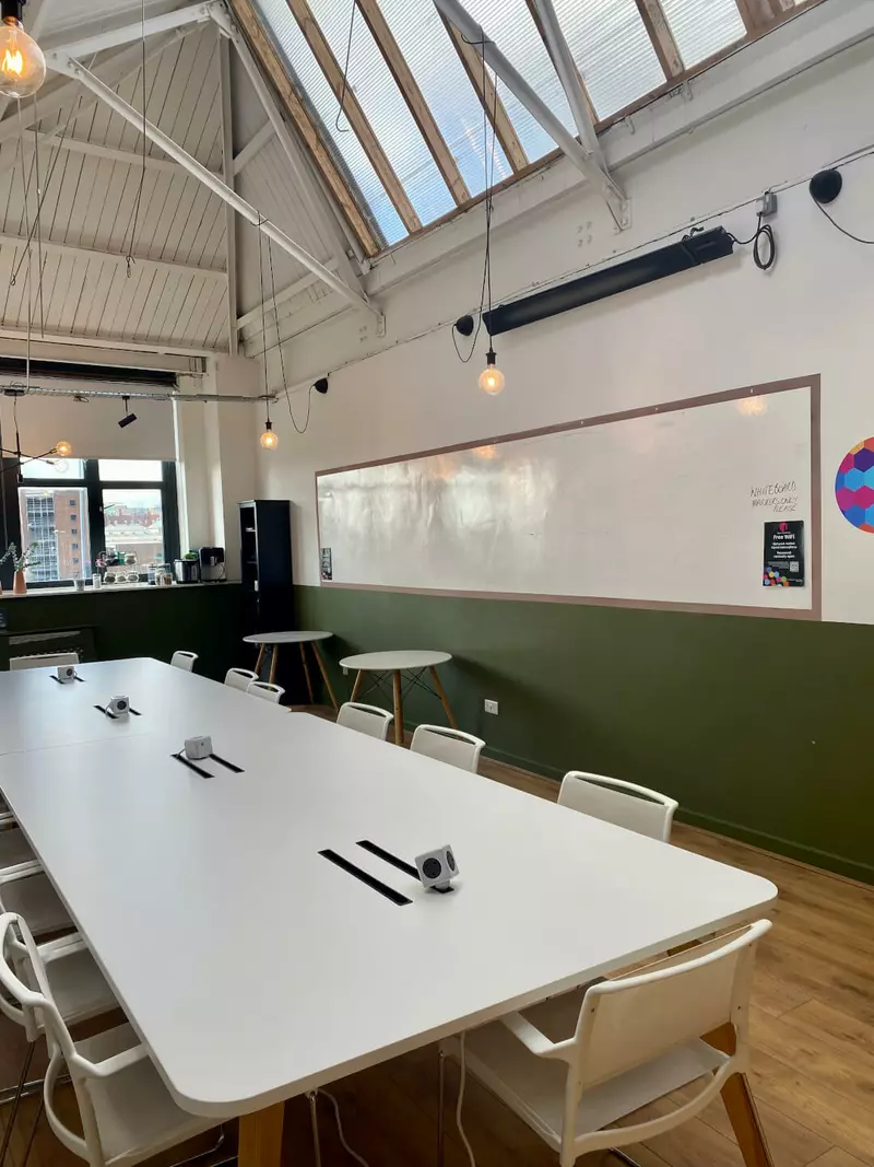 A large conference table and a whiteboard wall