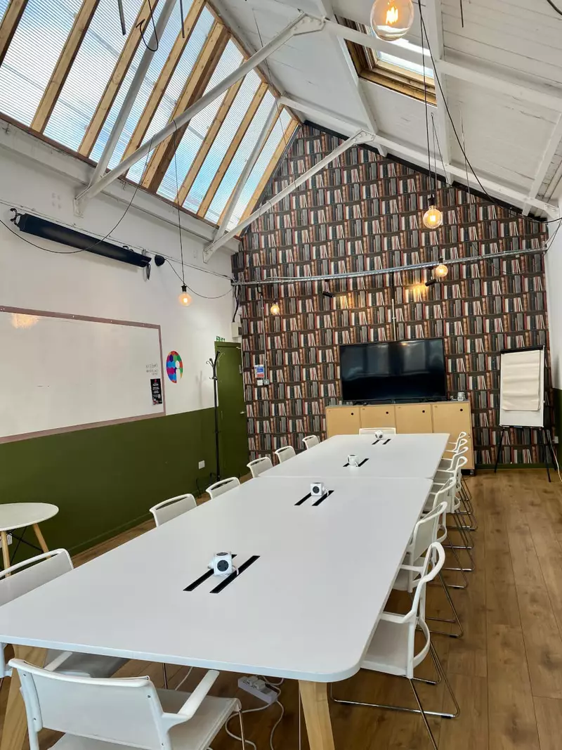 Conference table with a large TV and a feature wall