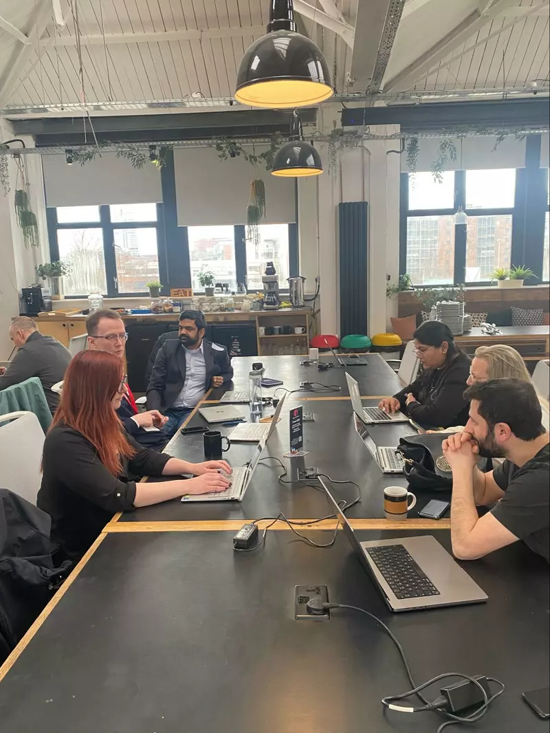 People sat working at big desks